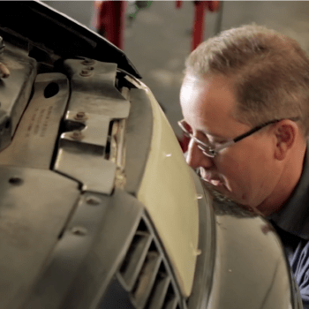 Curt's Auto Employee Fixing Tire Curt's Auto Employee Fixing Tire